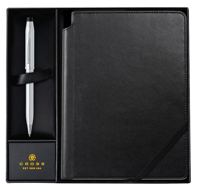 Black leather-bound notebook with a pen in a box, featuring the Cross brand.