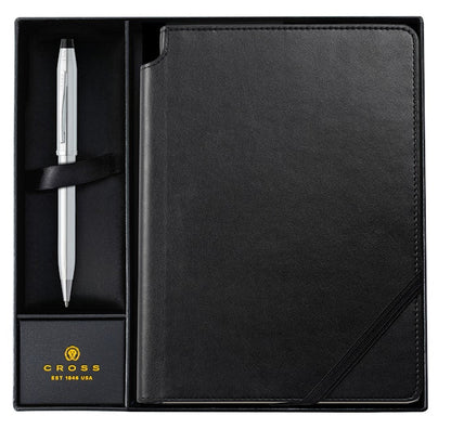 Black leather-bound notebook with a pen in a box, featuring the Cross brand.
