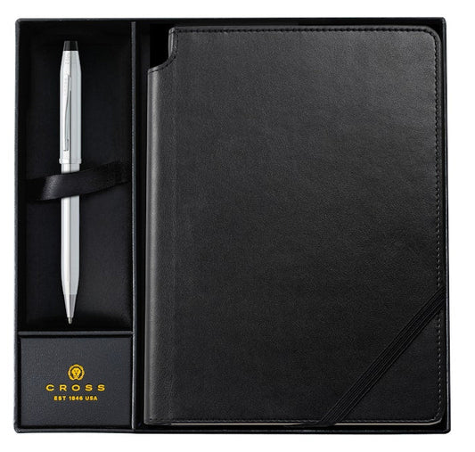 Black leather-bound notebook with a pen in a box, featuring the Cross brand.